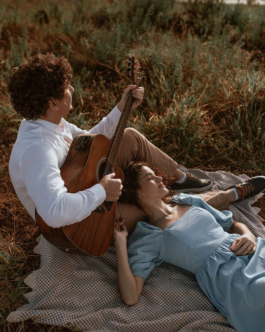 two people sitting outdoors.